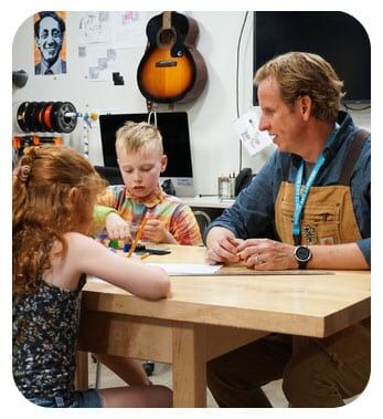 Students and teacher working at a table at Bennett Day School