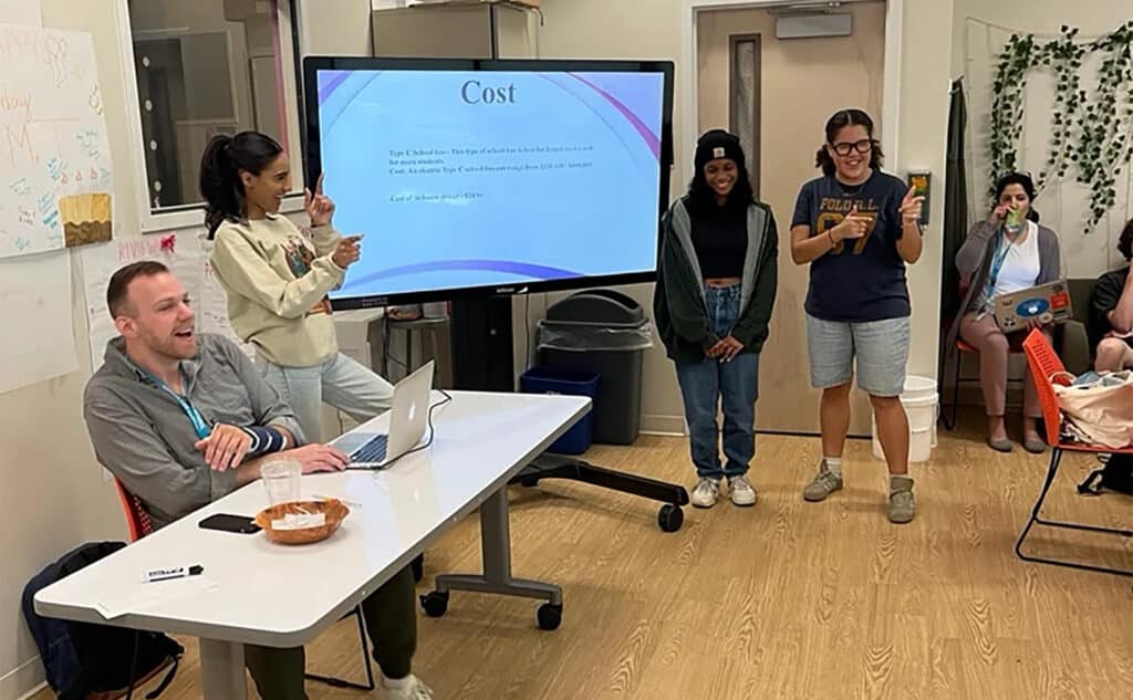 High school teacher provides feedback to students